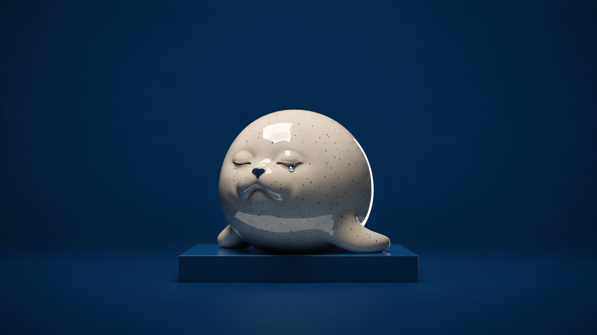 A glazed ceramic seal with a single tear, resting on a navy plinth